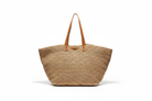 Raffia tote bag on white backdrop